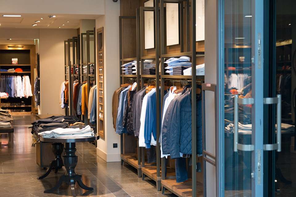 upscale retail store with racks of collared shirts 